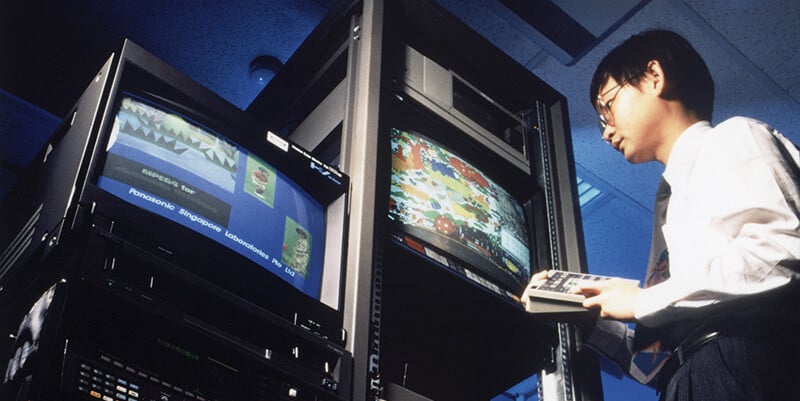 Vintage 1980s photo of a man testing Panasonic video equipment.