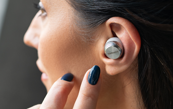 A woman wearing Panasonic's EAH-AZ100 Technics wireless earbuds