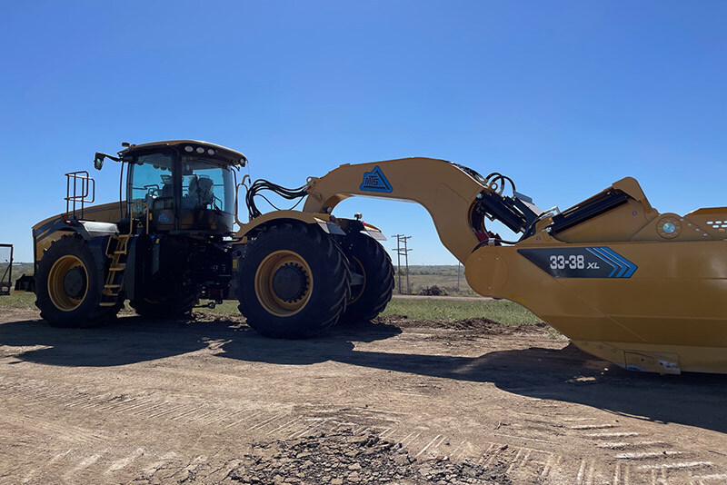An excavator breaks ground at the site of the new EV battery facility in De Soto, Kansas