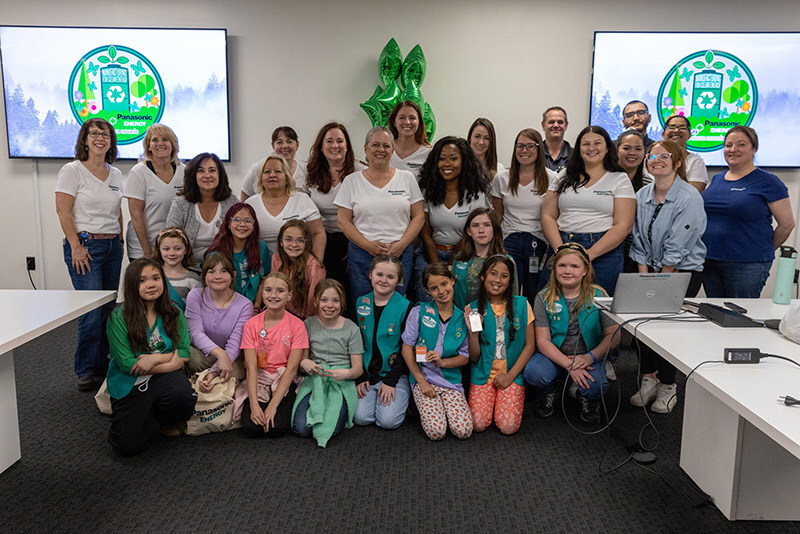Employees of Panasonic Energy pose with Girls Scouts of the Sierra Nevada