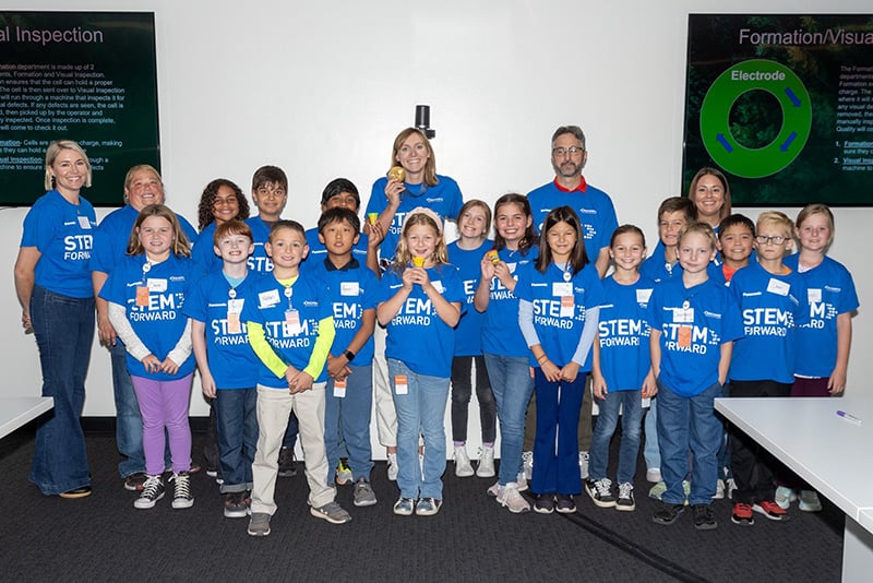 Olympic Gold Medalist Katie Ledecky poses with students at a STEM Forward event
