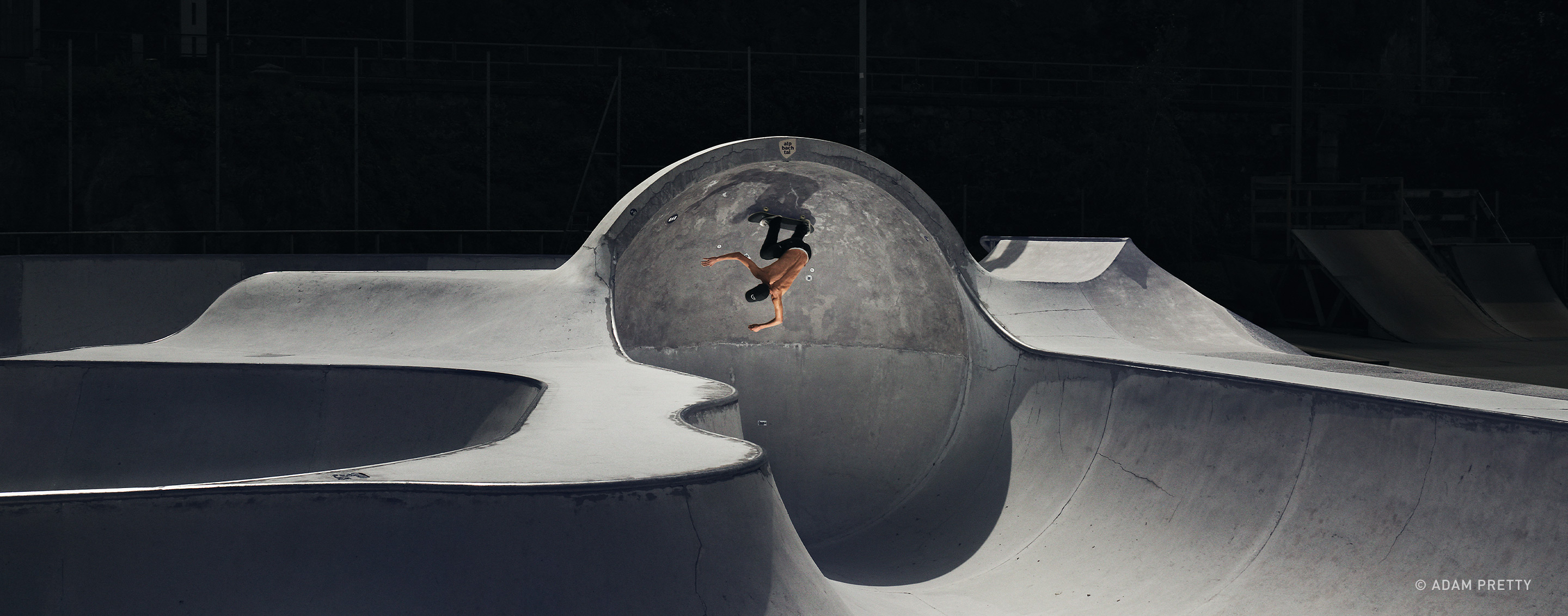 skateboarder upside down on a half pipe