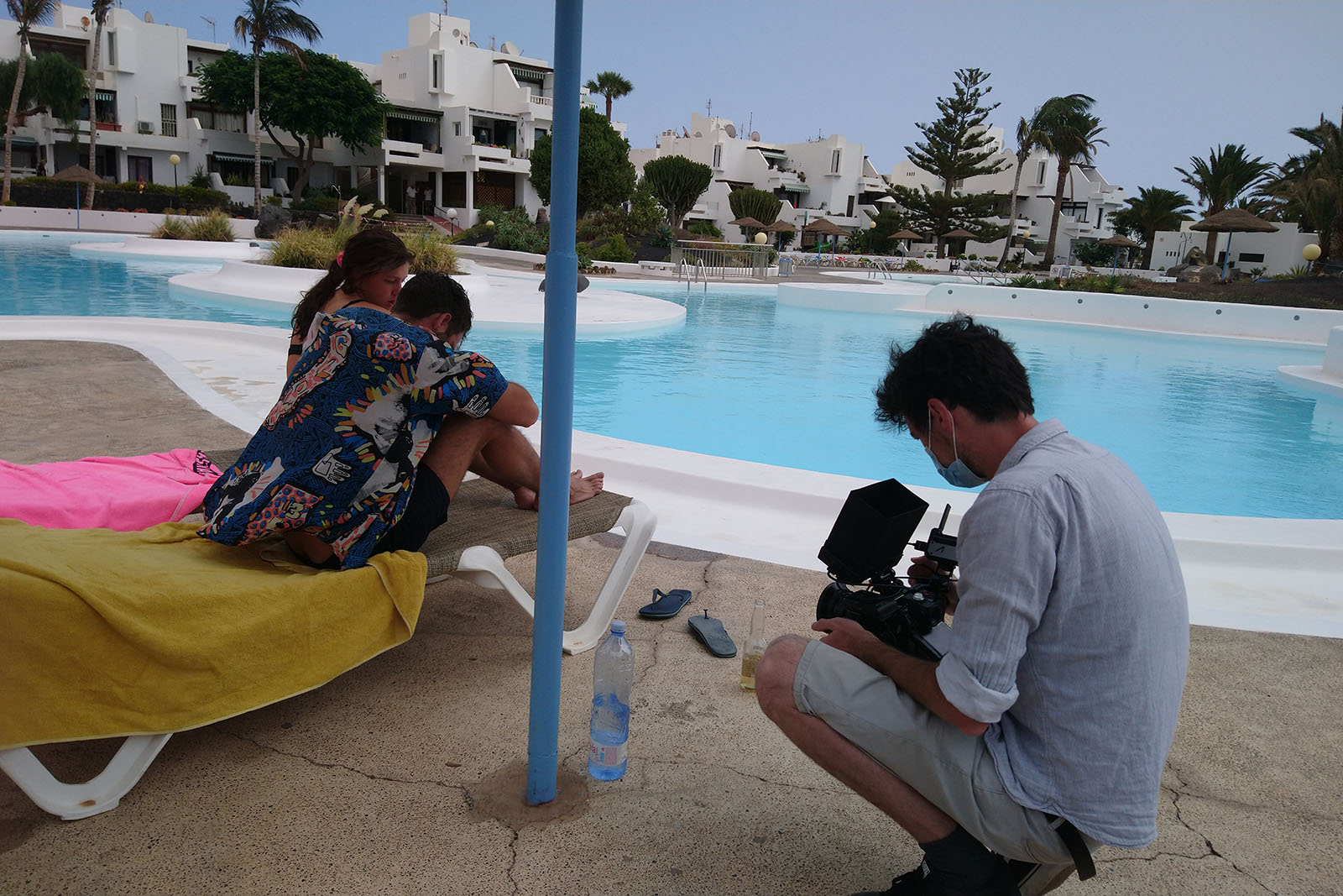 DP Olivier Boonjing shooting a low angle shot of a couple by a pool
