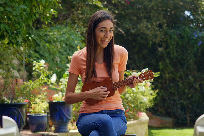Amber playing a ukulele