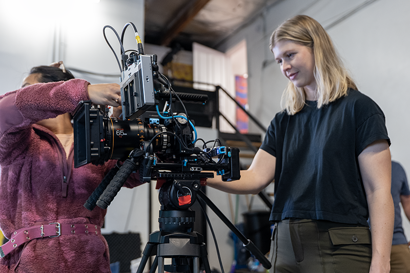Camera assistant adjusting cable and DP Carissa Dorson checking the frame