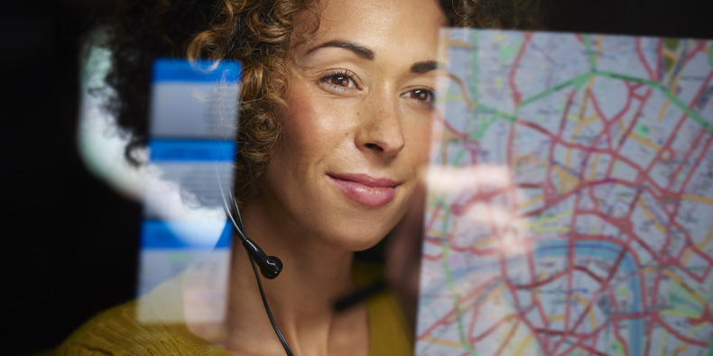 A concept image of a woman monitoring data from a connected intersection