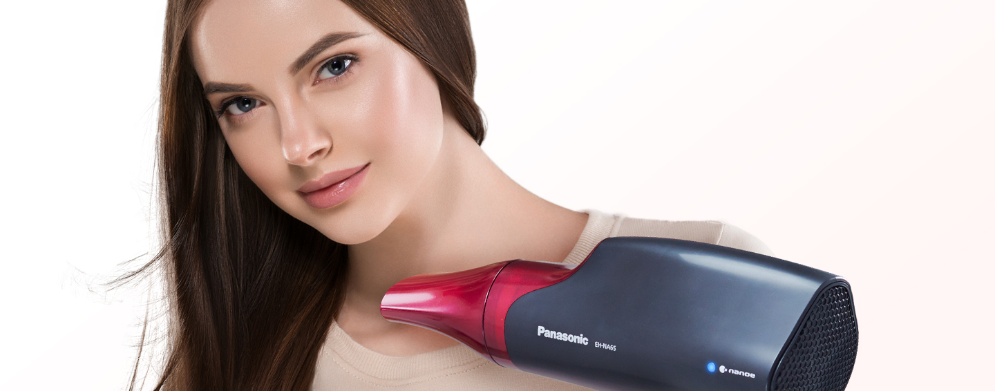 Woman with a Panasonic hair dryer in hand. 