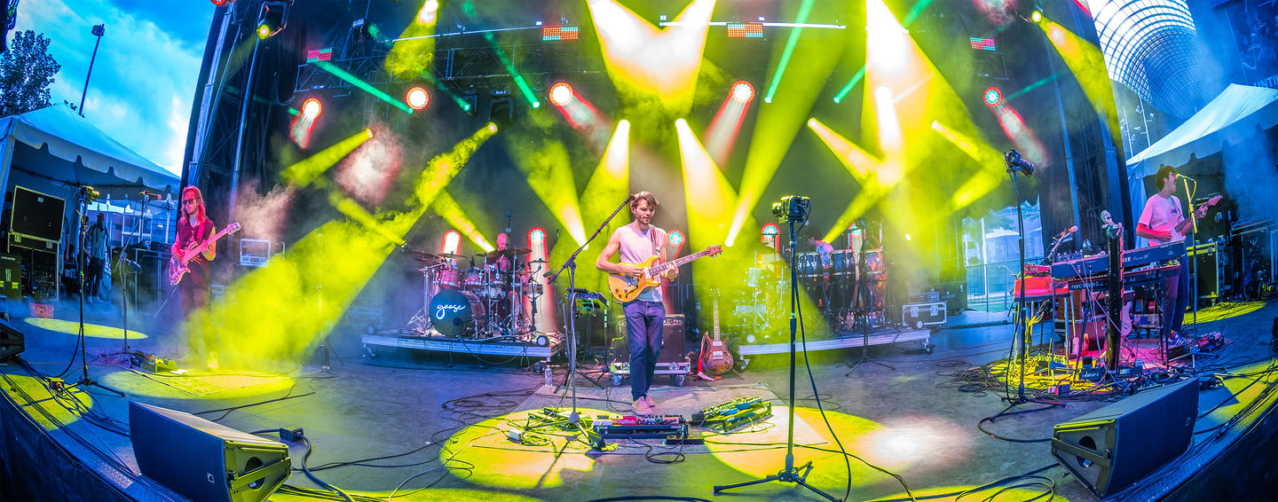 Goose performing live on stage with colorful lighting effects