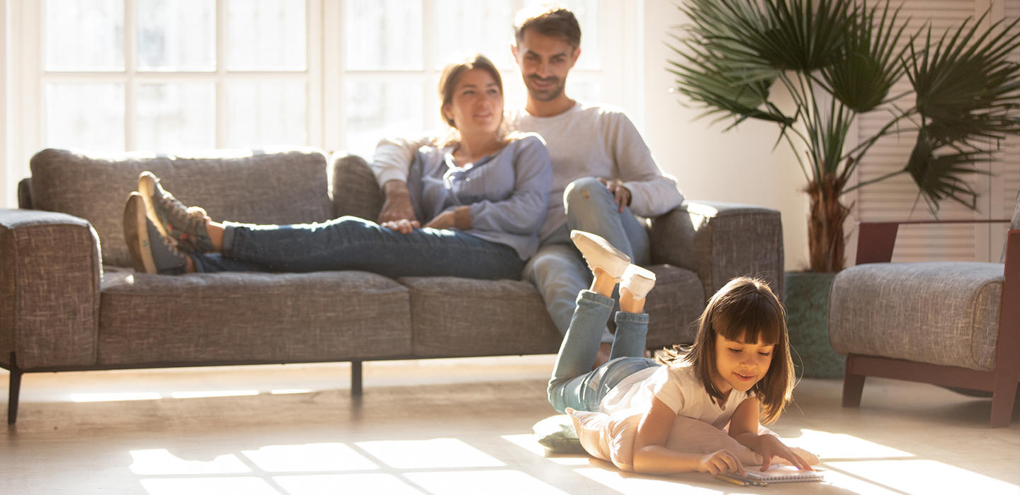 a happy family relaxes in their living room