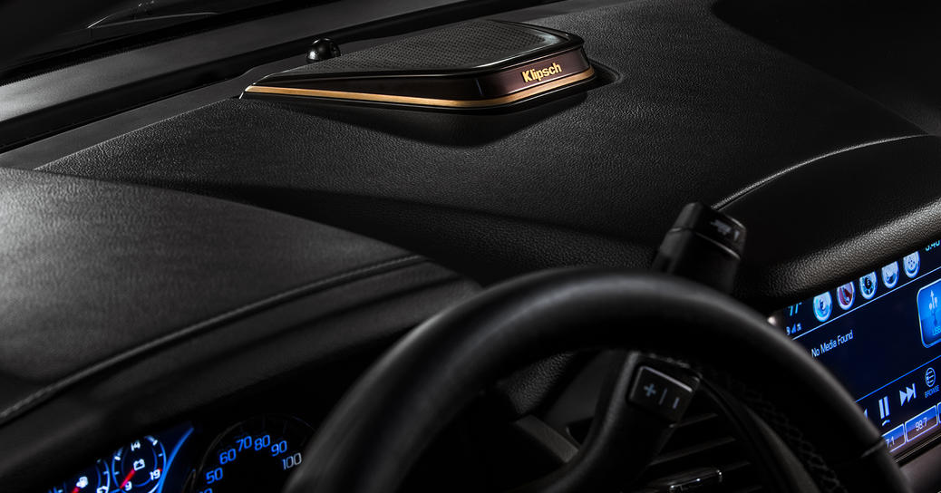 Car interior showing Klipsch Premium audio speaker on car dashboard