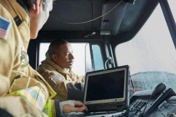 Two firefighters in truck with Panasonic TOUGHBOOK rugged computer