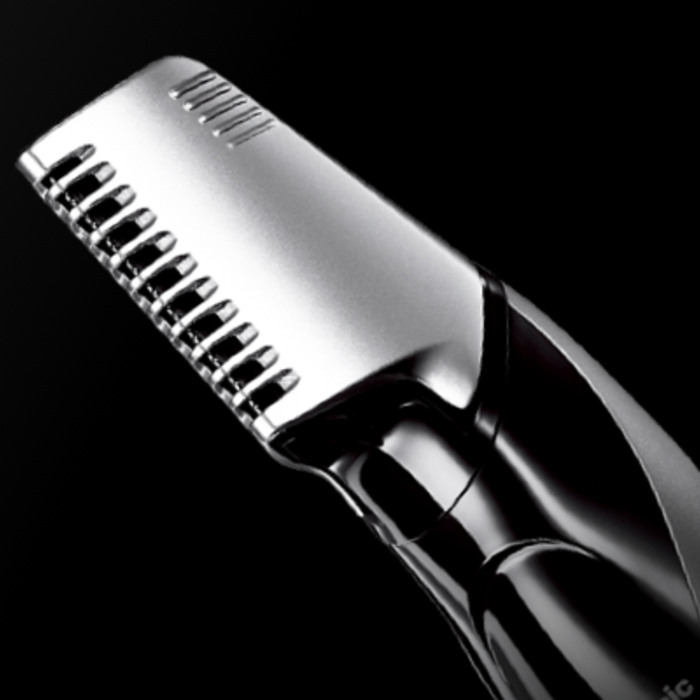 image of a Panasonic men's groomer, laying diagonally on a black background. 