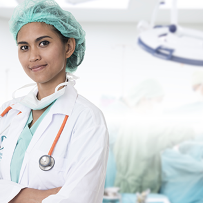 a doctor stands with her arms folded