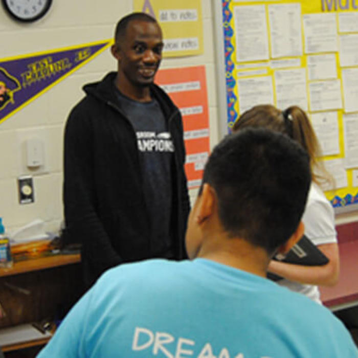 Lex Gillette speaks to a classroom of kids