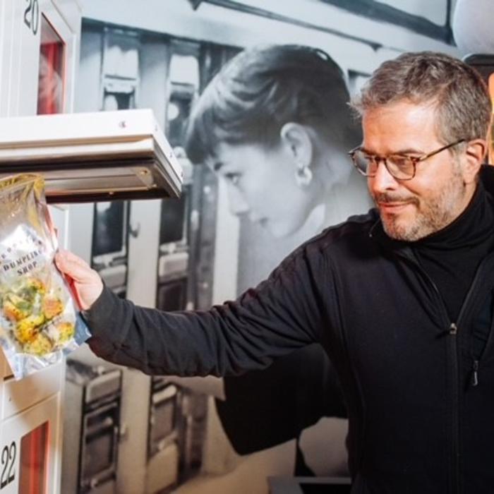 a man grabs his order from a secure smart food locker
