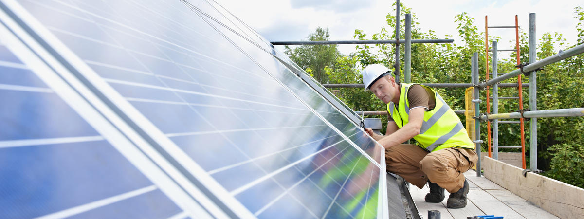 Caucasian technician working on solar panels