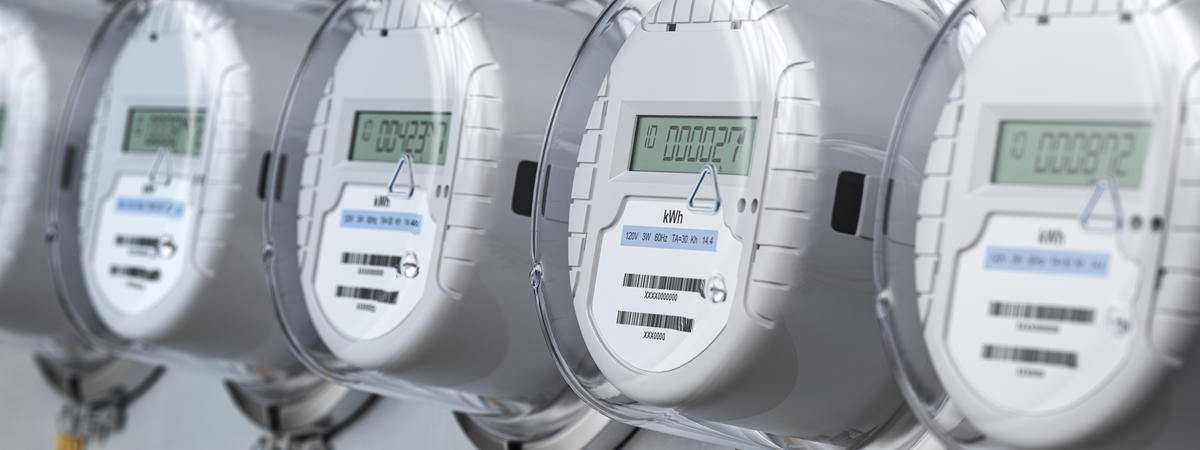 Digital electric meters in a row measuring power use. Electricity consumption concept.
