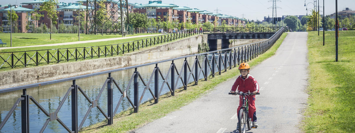 Little Boy Cycling On Line Near Canal